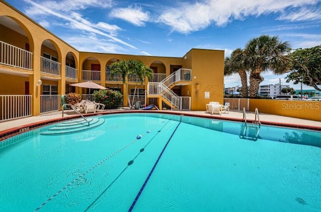 community pool with stairs and fence