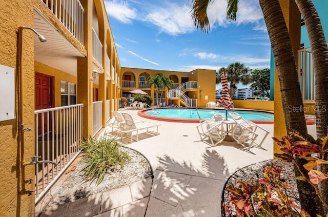 community pool featuring a patio area