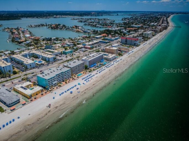 drone / aerial view featuring a beach view and a water view