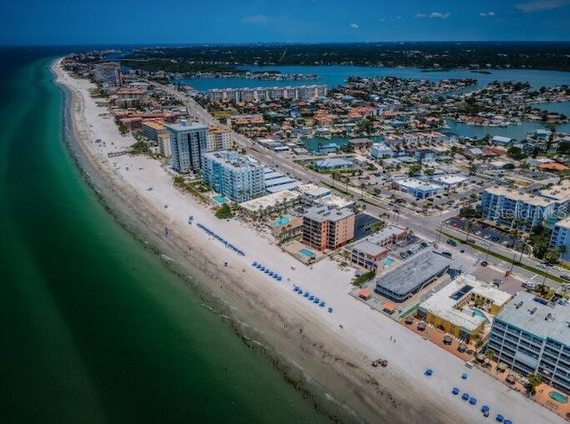 birds eye view of property with a view of the beach, a water view, and a city view