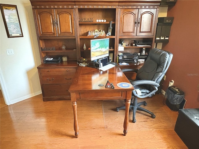 home office with wood finished floors and baseboards