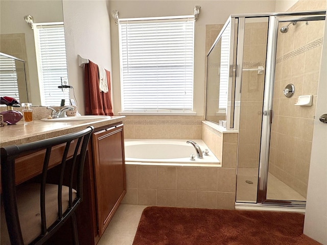 bathroom with a stall shower, a garden tub, and plenty of natural light