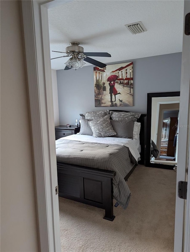 bedroom featuring visible vents, ceiling fan, and carpet floors