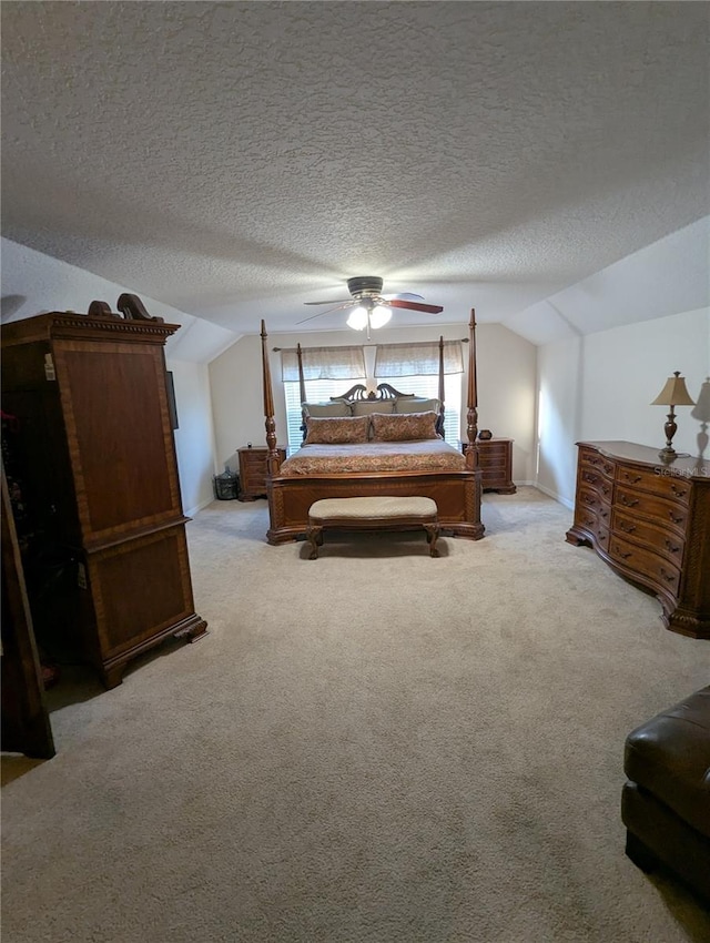 bedroom with lofted ceiling, a textured ceiling, and carpet flooring