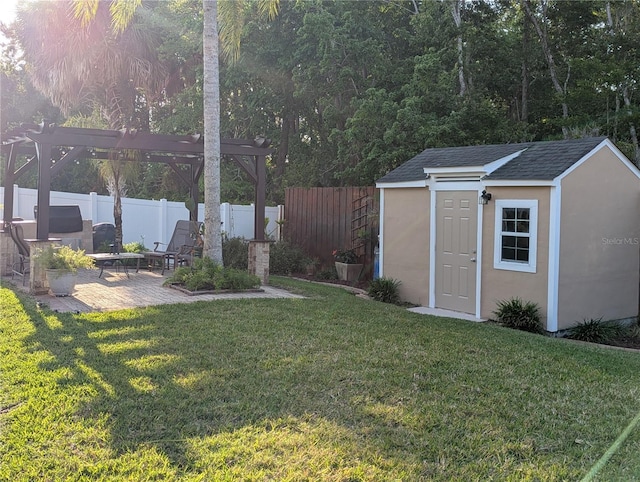 view of yard with fence, an outdoor structure, a patio area, and a pergola