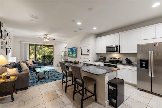 6225 Scarlet Darter Way, Tampa, FL 33625 - kitchen with stainless steel appliances, a sink, open floor plan, light tile patterned floors, and recessed lighting