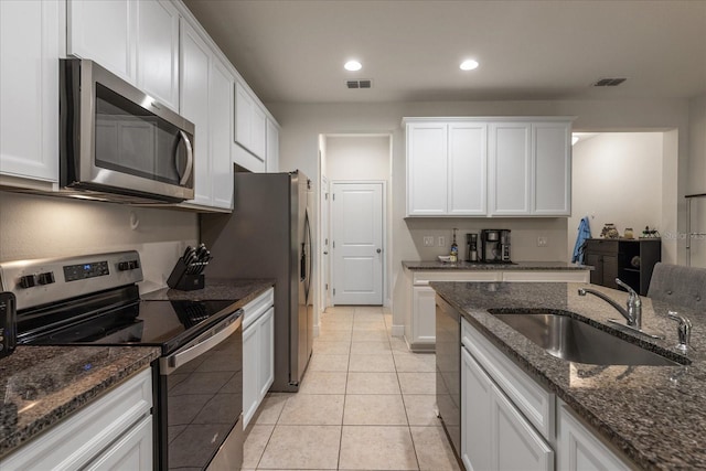 6225 Scarlet Darter Way, Tampa, FL 33625 - kitchen featuring stainless steel appliances, a sink, white cabinetry, recessed lighting, and dark stone counters