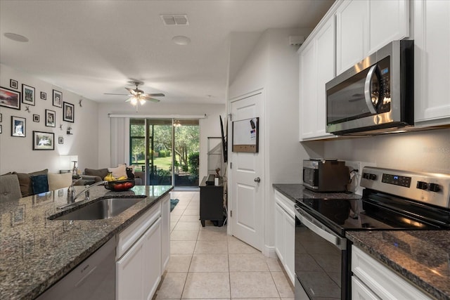 6225 Scarlet Darter Way, Tampa, FL 33625 - kitchen featuring stainless steel appliances, a sink, open floor plan, and white cabinets