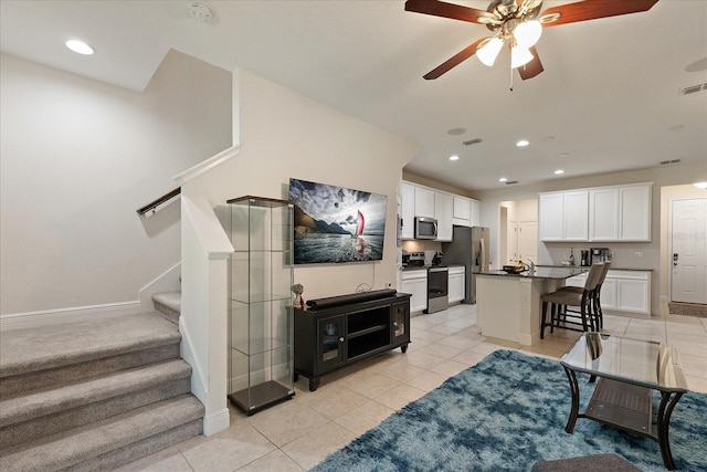 6225 Scarlet Darter Way, Tampa, FL 33625 - living room with ceiling fan, light tile patterned floors, stairway, baseboards, and recessed lighting