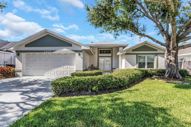 ranch-style home with stucco siding, a front yard, concrete driveway, and a garage