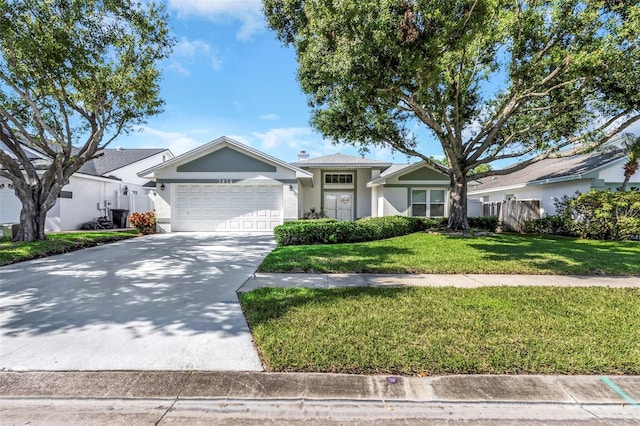 ranch-style house with a garage, driveway, fence, a front yard, and stucco siding