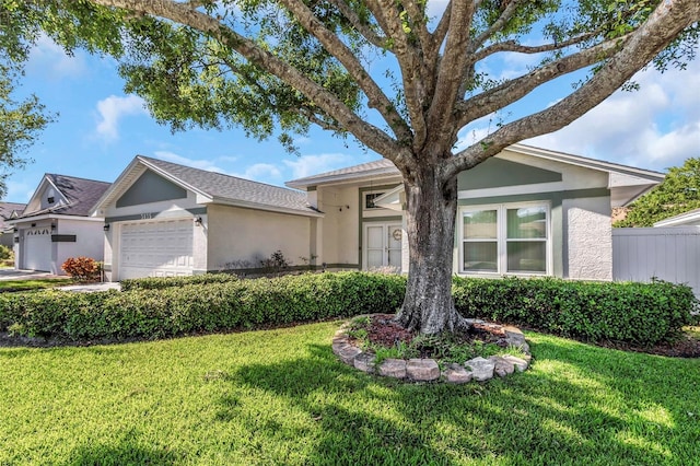 ranch-style house with stucco siding, a front lawn, and a garage