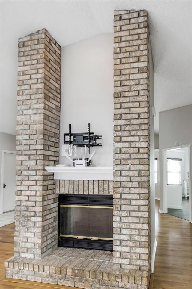 interior details featuring a fireplace and wood finished floors
