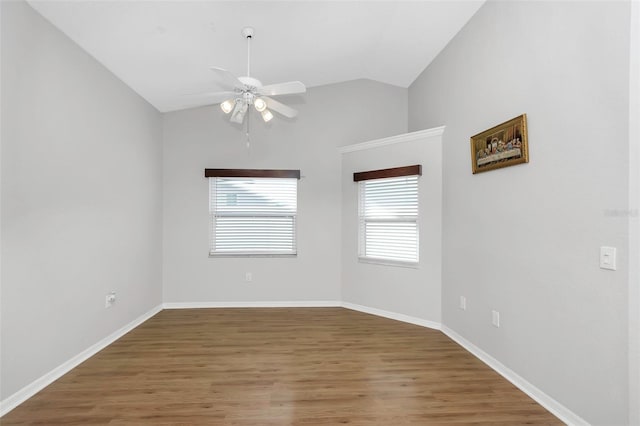 empty room featuring baseboards, lofted ceiling, a ceiling fan, and light wood-type flooring