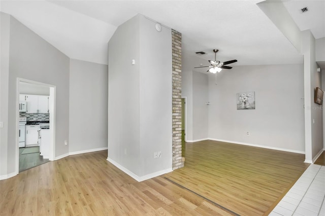 empty room featuring ceiling fan, baseboards, visible vents, and light wood finished floors