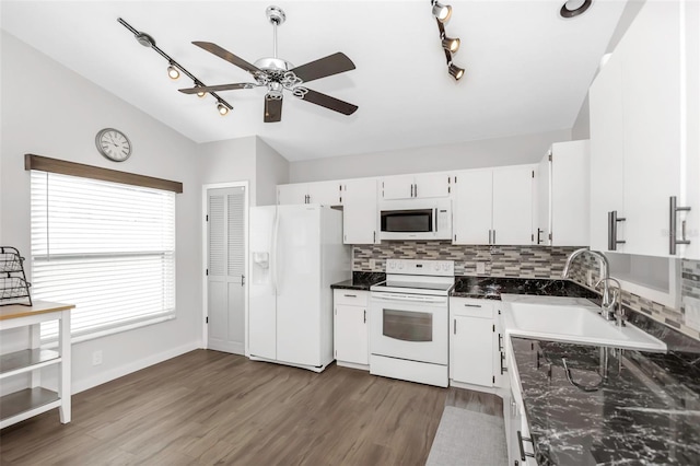 kitchen with a sink, tasteful backsplash, wood finished floors, white appliances, and ceiling fan