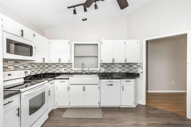 kitchen featuring a sink, decorative backsplash, white appliances, ceiling fan, and lofted ceiling