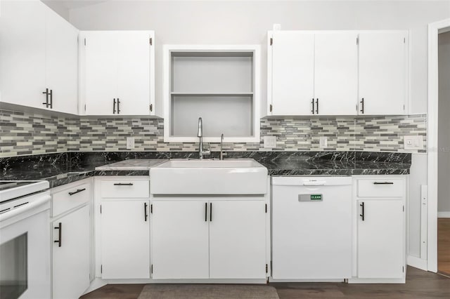 kitchen with white cabinets, a sink, white dishwasher, tasteful backsplash, and range