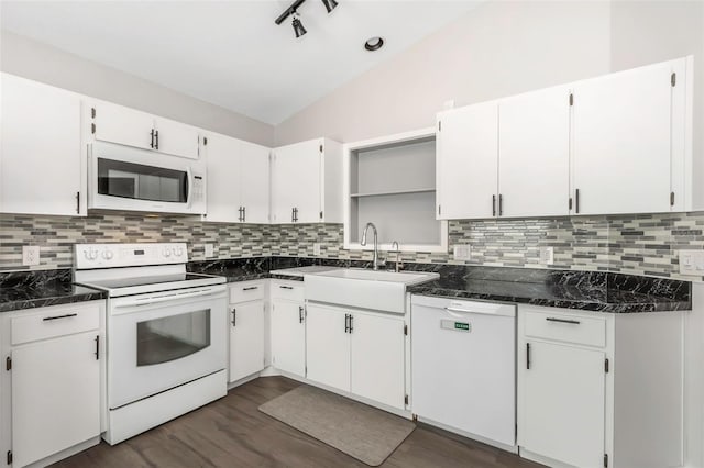 kitchen with dark wood-type flooring, tasteful backsplash, a sink, and white appliances