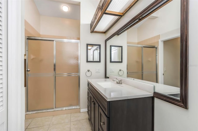bathroom featuring vanity, tile patterned flooring, and a shower stall
