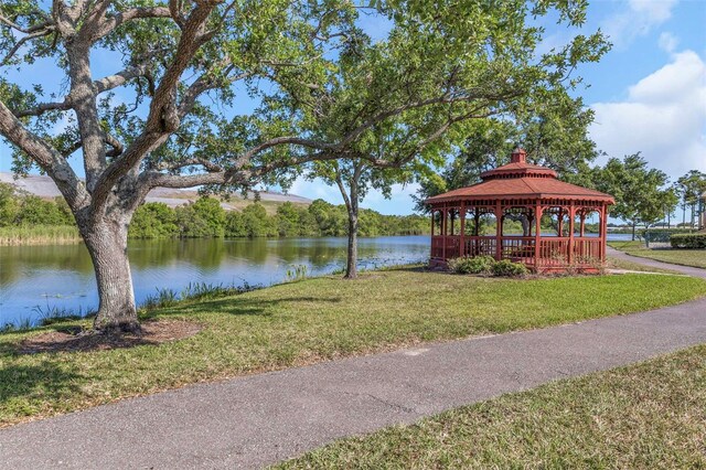 view of home's community with a gazebo, a lawn, and a water view