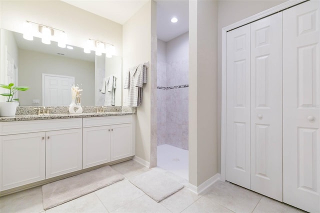 5059 Bromeliad Ave, Wimauma, FL 33598 - full bath with a closet, double vanity, tile patterned flooring, walk in shower, and baseboards