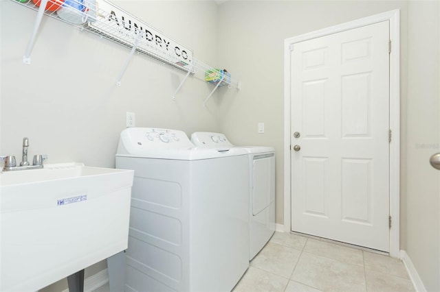 5059 Bromeliad Ave, Wimauma, FL 33598 - laundry room featuring washer and clothes dryer, baseboards, and light tile patterned floors