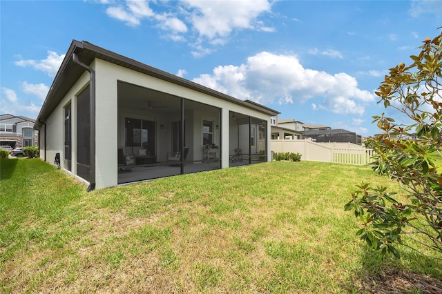 5059 Bromeliad Ave, Wimauma, FL 33598 - rear view of property featuring a sunroom, a ceiling fan, and stucco siding