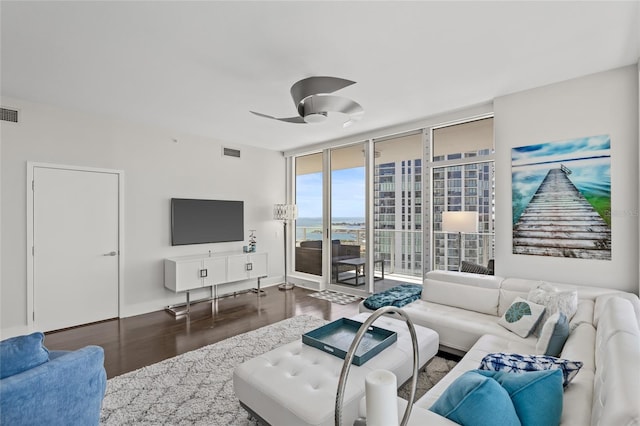 175 1st St S Unit 2603, Saint Petersburg, FL 33701 - living area featuring a ceiling fan, visible vents, baseboards, a wall of windows, and wood finished floors