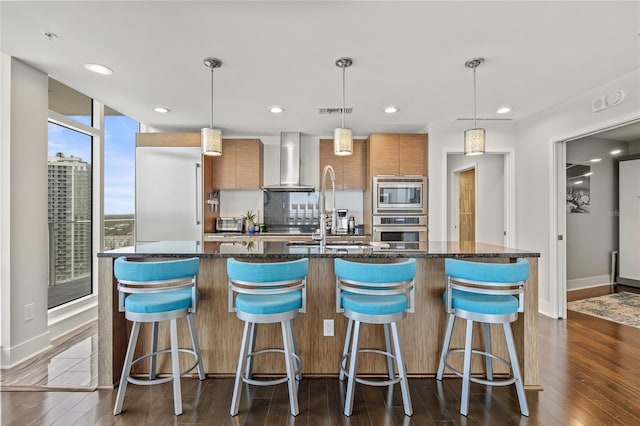 175 1st St S Unit 2603, Saint Petersburg, FL 33701 - kitchen featuring dark wood-type flooring, stainless steel appliances, modern cabinets, and wall chimney range hood