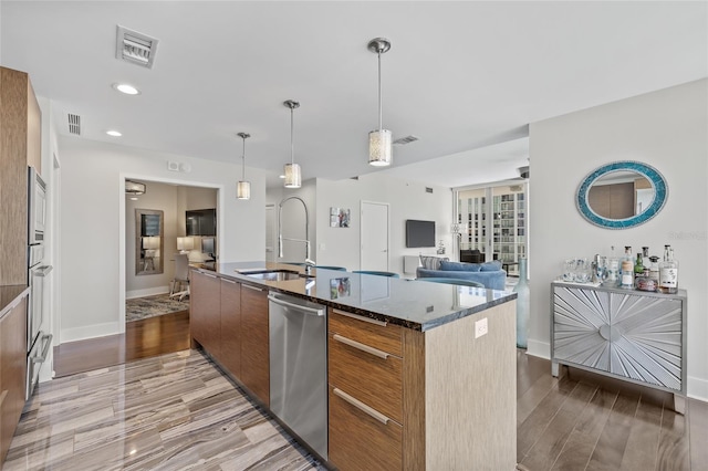 175 1st St S Unit 2603, Saint Petersburg, FL 33701 - kitchen featuring dark stone countertops, brown cabinets, stainless steel dishwasher, visible vents, and open floor plan