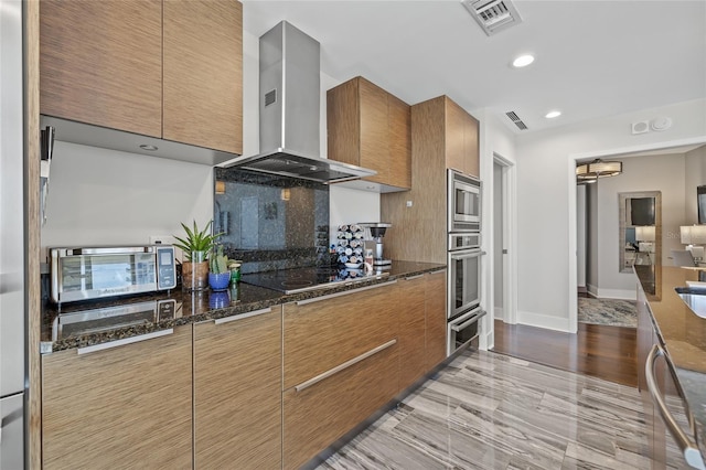 175 1st St S Unit 2603, Saint Petersburg, FL 33701 - kitchen with dark stone counters, range hood, visible vents, and stainless steel appliances