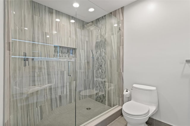 175 1st St S Unit 2603, Saint Petersburg, FL 33701 - full bathroom featuring tile patterned floors, toilet, a stall shower, and baseboards