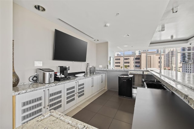 175 1st St S Unit 2603, Saint Petersburg, FL 33701 - interior space featuring light stone countertops, a sink, and dark tile patterned floors