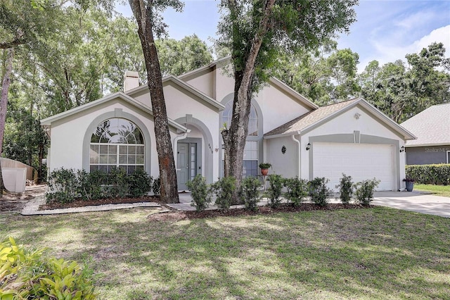 6410 Beaver Way, Tampa, FL 33625 - view of front of property with a chimney, a front yard, a garage, concrete driveway, and stucco siding