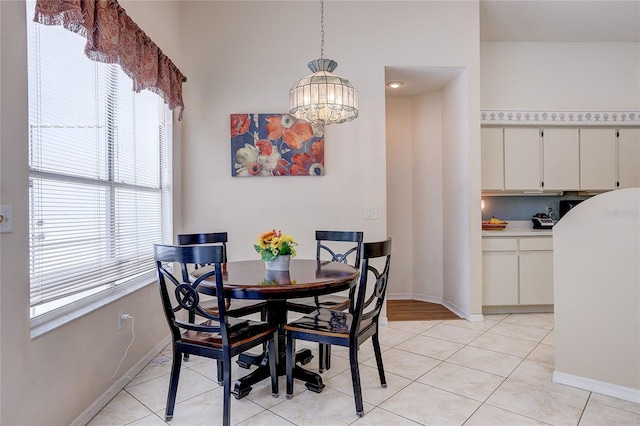 6410 Beaver Way, Tampa, FL 33625 - dining room featuring plenty of natural light, baseboards, light tile patterned floors, and a chandelier