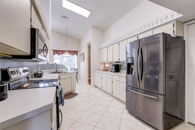 6410 Beaver Way, Tampa, FL 33625 - kitchen with appliances with stainless steel finishes, light countertops, light tile patterned floors, a chandelier, and white cabinetry
