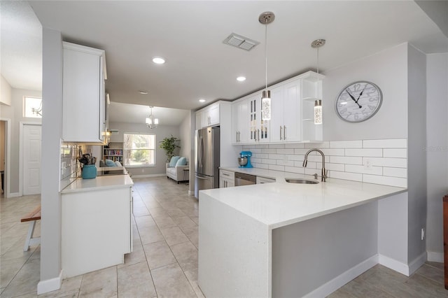 1916 Sandstone Pl, Clearwater, FL 33760 - kitchen featuring visible vents, baseboards, light countertops, a sink, and stainless steel appliances