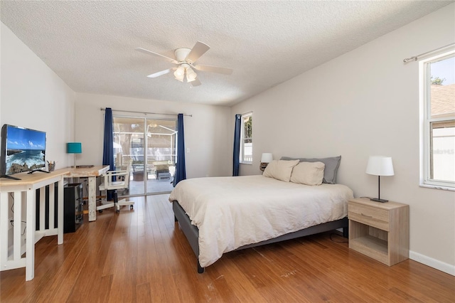 1916 Sandstone Pl, Clearwater, FL 33760 - bedroom with a textured ceiling, access to outside, and wood finished floors