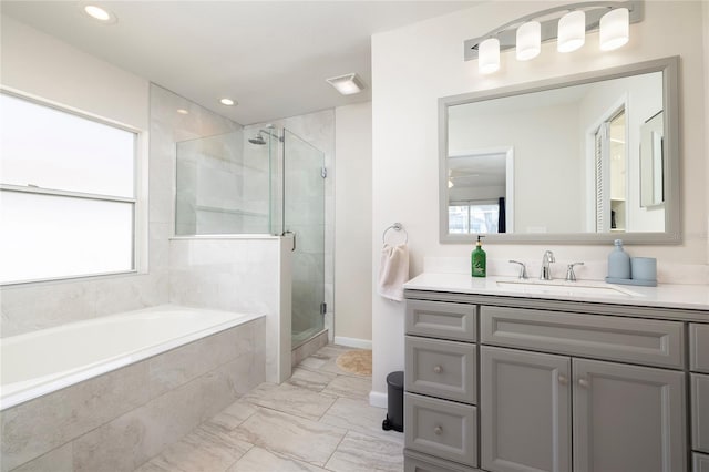 1916 Sandstone Pl, Clearwater, FL 33760 - full bathroom featuring marble finish floor, a shower stall, a healthy amount of sunlight, and a garden tub