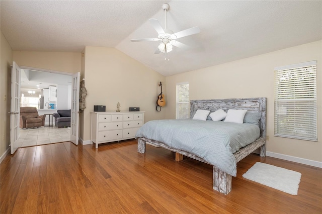 1916 Sandstone Pl, Clearwater, FL 33760 - bedroom featuring baseboards, lofted ceiling, wood finished floors, and ceiling fan