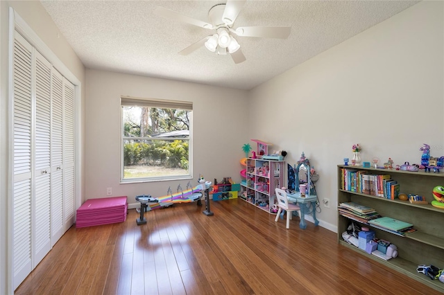 1916 Sandstone Pl, Clearwater, FL 33760 - playroom with baseboards, a textured ceiling, ceiling fan, and wood finished floors