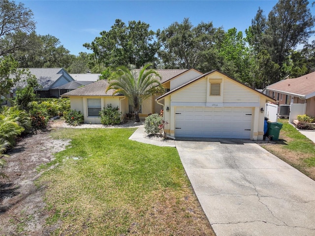 1916 Sandstone Pl, Clearwater, FL 33760 - view of front facade with an attached garage, stucco siding, driveway, and a front yard