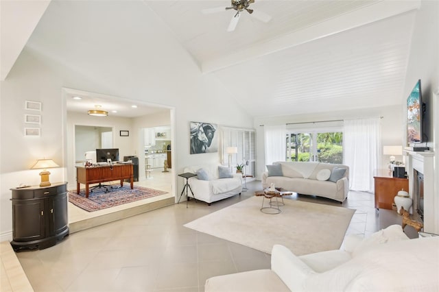 living area with a ceiling fan, beamed ceiling, and high vaulted ceiling