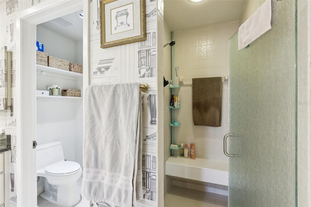bathroom with toilet and a shower stall