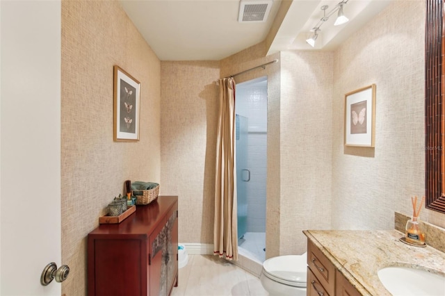 bathroom with toilet, track lighting, visible vents, a shower stall, and vanity