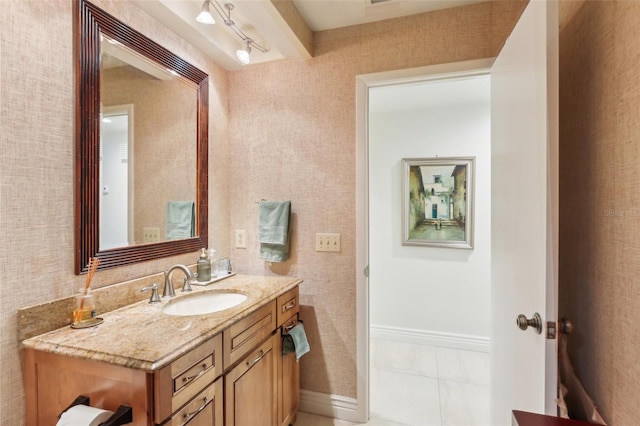 bathroom featuring baseboards and vanity