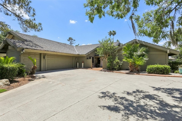 ranch-style house with driveway and an attached garage