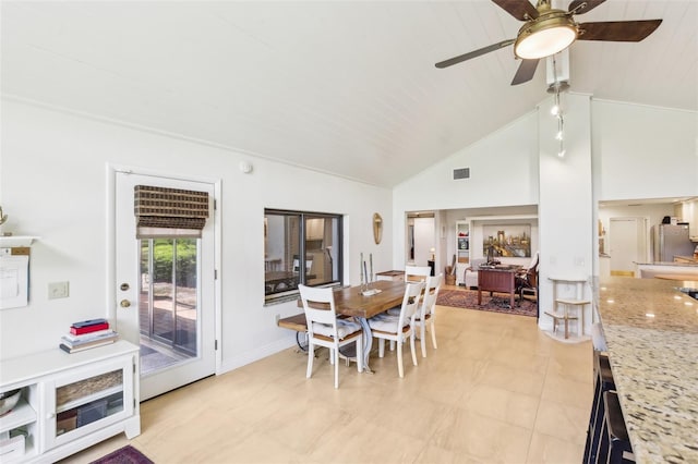 dining area featuring a ceiling fan, baseboards, visible vents, and high vaulted ceiling