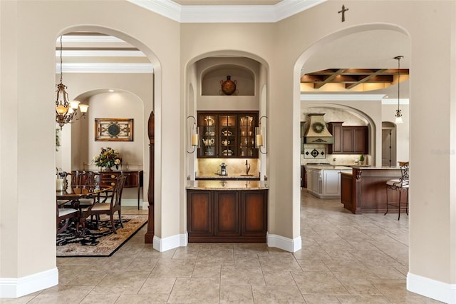 bar featuring tasteful backsplash, arched walkways, coffered ceiling, ornamental molding, and beam ceiling
